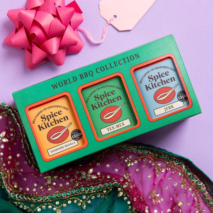 Spice Kitchen World BBQ Collection packaging with a pink bow and tag on a purple background