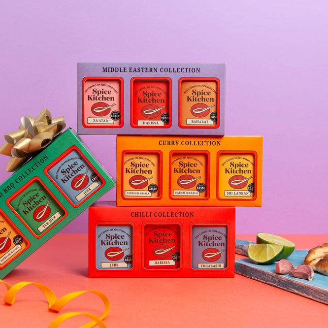 Collection of Spice Kitchen spice boxes on a colorful background