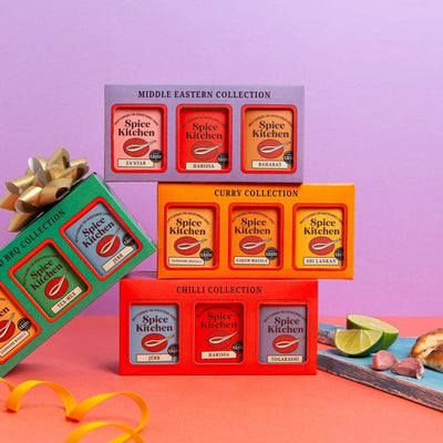 Collection of Spice Kitchen spice boxes on a colorful background