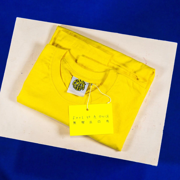 Embroidered T-shirt: Fool of a Kind - Yellow/Red - Migration Museum Shop